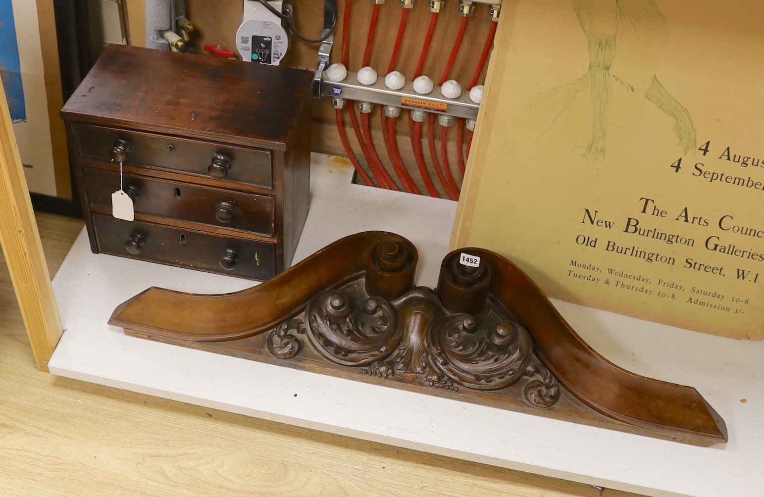 A Victorian mahogany miniature three drawer chest and a carved mahogany furniture pediment, 97cms wide